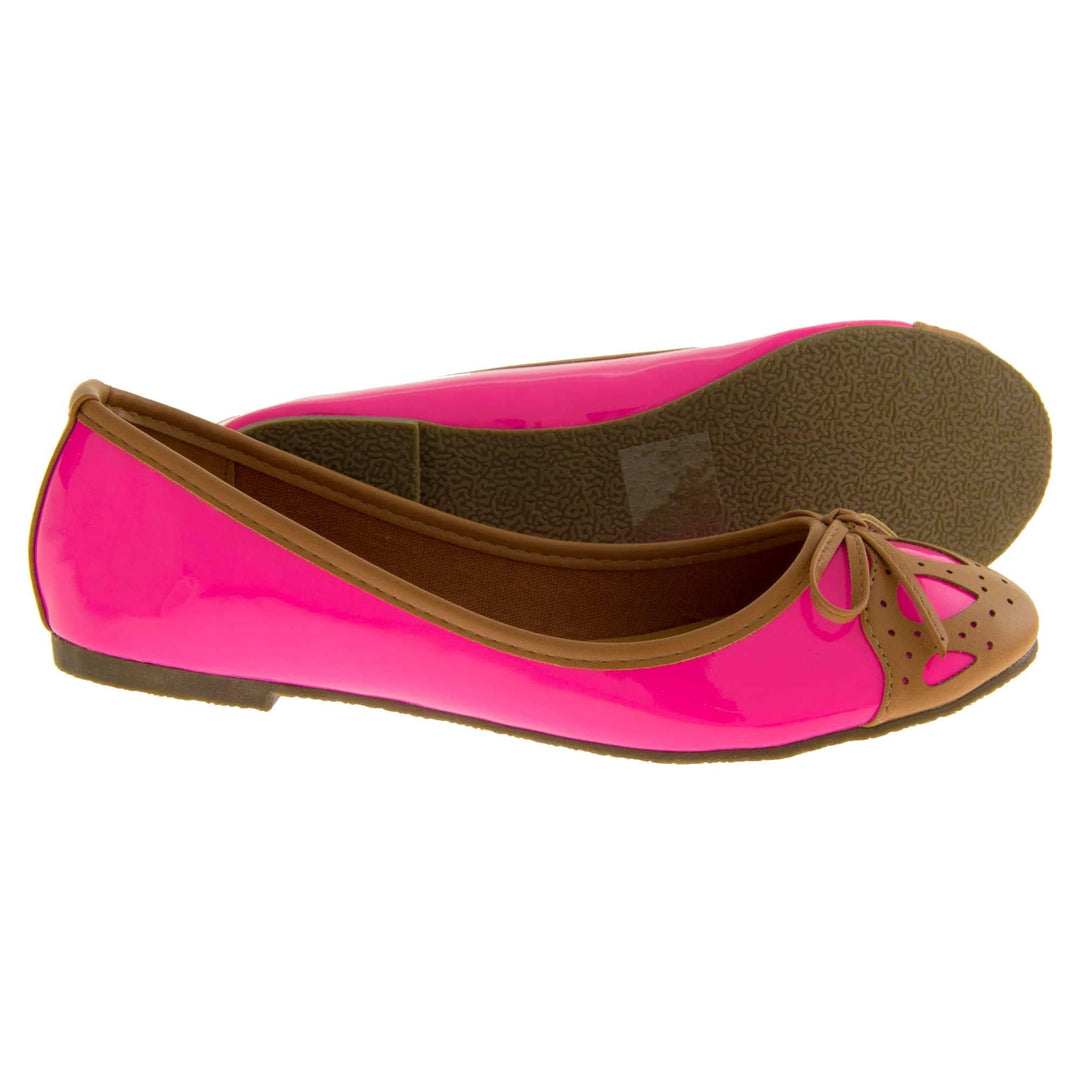 Womens ballerina shoe. Pink patent leather effect ballet pumps with brown faux leather collar and detailing to the toe. Brown sole with a very slight heel. Both feet from a side profile with the left foot on its side to show the sole.