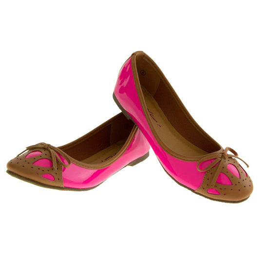 Womens ballerina shoe. Pink patent leather effect ballet pumps with brown faux leather collar and detailing to the toe. Brown sole with a very slight heel. Both feet in a V shape with the heel of the left foot leaning on top of the right heel.