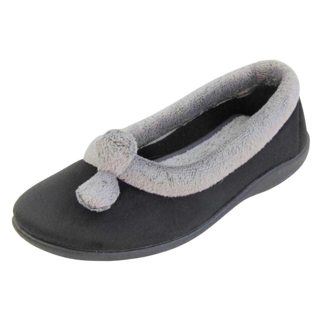 Womens ballerina slippers. Womens ballerina style slippers with black velour uppers. Grey, plush textile collar and two pom poms to the front of the shoe. Matching textile lining. Firm black sole. Left foot at an angle.