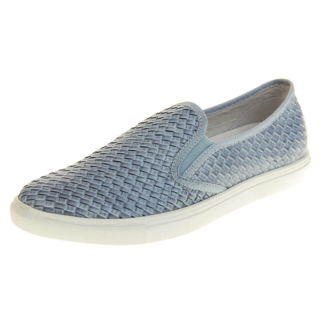 Womens blue loafers. Slip on loafer style shoe with a pale blue woven textile upper. Blue elasticated side gussets and plain blue textile around collar. White flat sole and cream leather lining. Left foot at an angle.