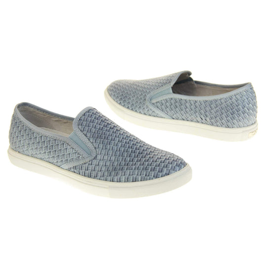 Womens blue loafers. Slip on loafer style shoe with a pale blue woven textile upper. Blue elasticated side gussets and plain blue textile around collar. White flat sole and cream leather lining. Both feet at an angle facing top to tail.