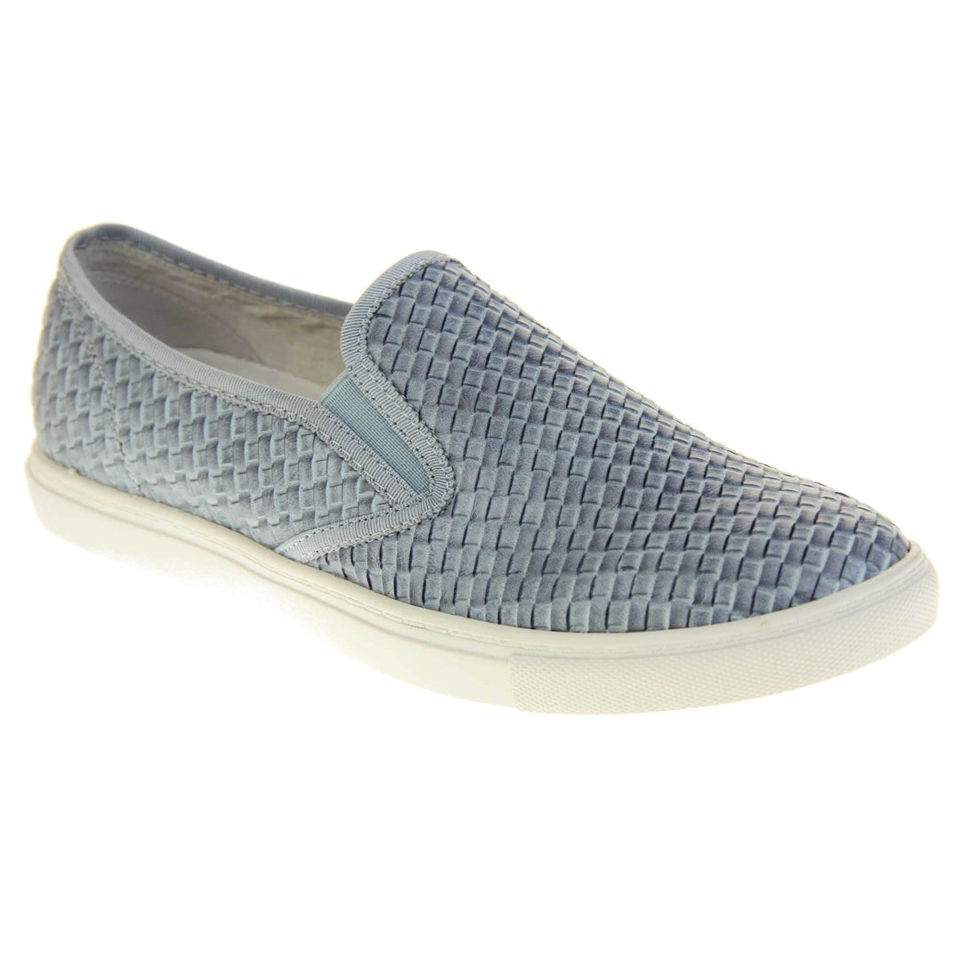 Womens blue loafers. Slip on loafer style shoe with a pale blue woven textile upper. Blue elasticated side gussets and plain blue textile around collar. White flat sole and cream leather lining. Right foot at an angle.