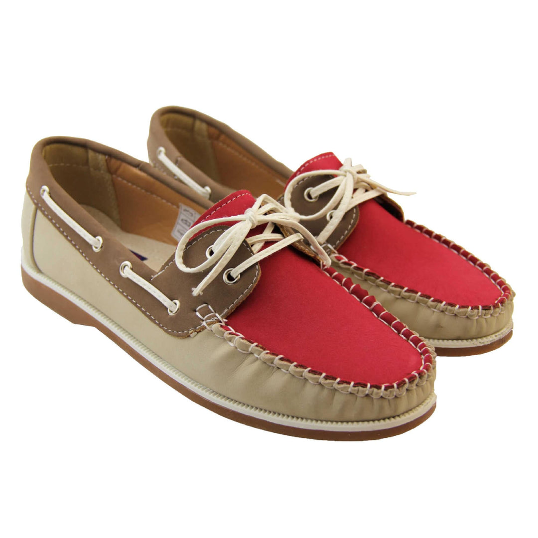 Womens Deck Shoes with Laces - Fuchsia Pink upper and tongue with contrast stitching and lace up fastening. Beige PU upper to sides and tan brown cuff and rim, with tan soles with white above. Lace cords to side in lines with eyelets in boat shoe design. Both feet view from above.