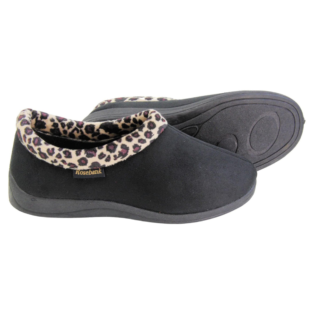 Womens bootie slippers. Womens low top bootie style slippers with black velour uppers. Leopard print plush textile collar. Black textile lining. Firm black sole. Both feet from a side profile with the left foot on its side behind the the right foot to show the sole.