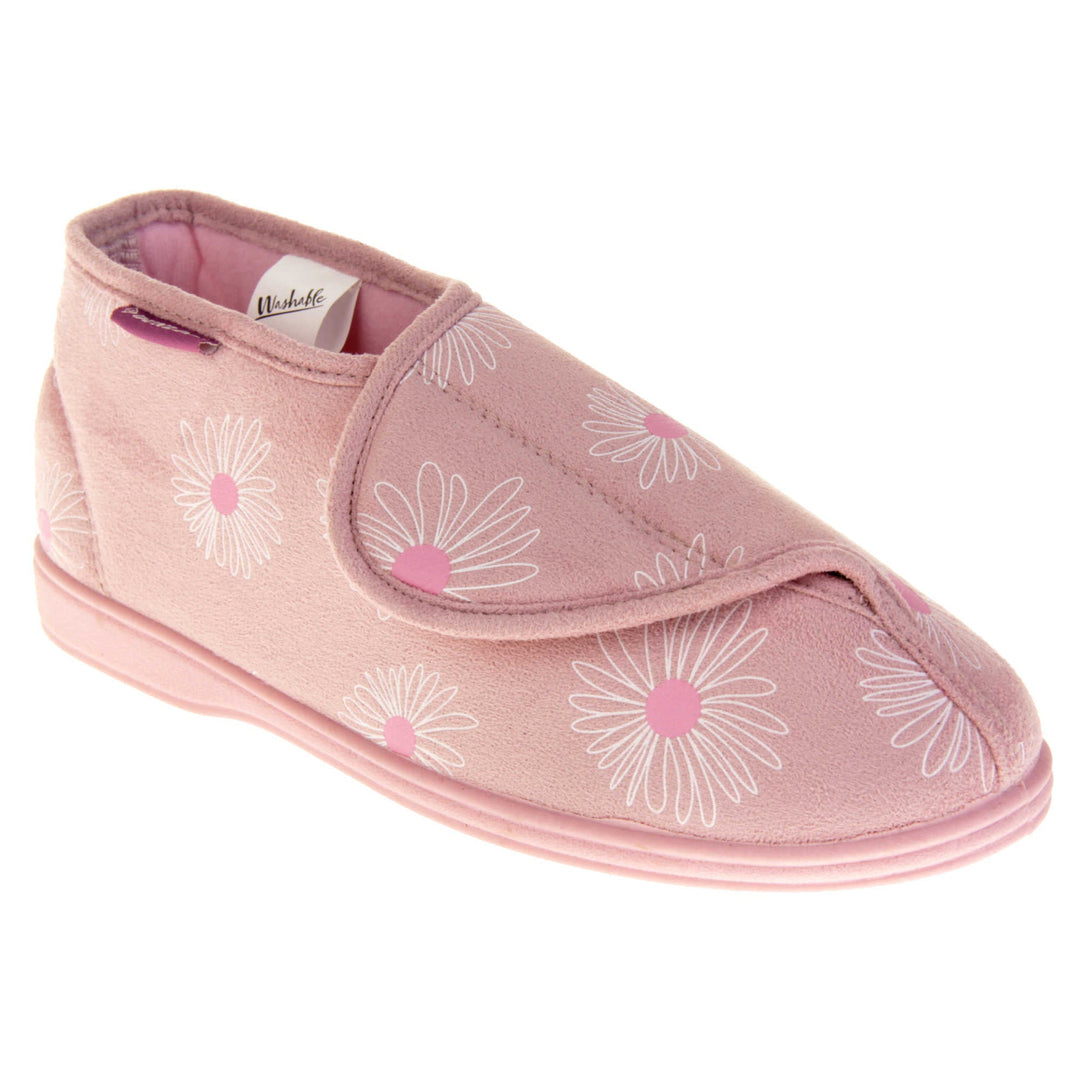 Womens bootie slippers. Ladies bootie style slipper with a pale pink textile upper with a white and pink flower print. Touch fasten tab to the top and pink textile lining. Firm pink sole. Right foot at an angle.