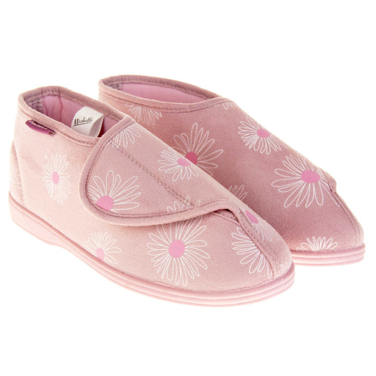 Womens bootie slippers. Ladies bootie style slipper with a pale pink textile upper with a white and pink flower print. Touch fasten tab to the top and pink textile lining. Firm pink sole. Both feet together at angle.