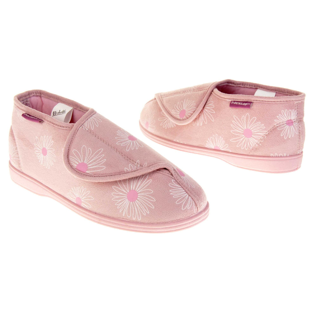 Womens bootie slippers. Ladies bootie style slipper with a pale pink textile upper with a white and pink flower print. Touch fasten tab to the top and pink textile lining. Firm pink sole. Both feet at an angle, facing top to tail.
