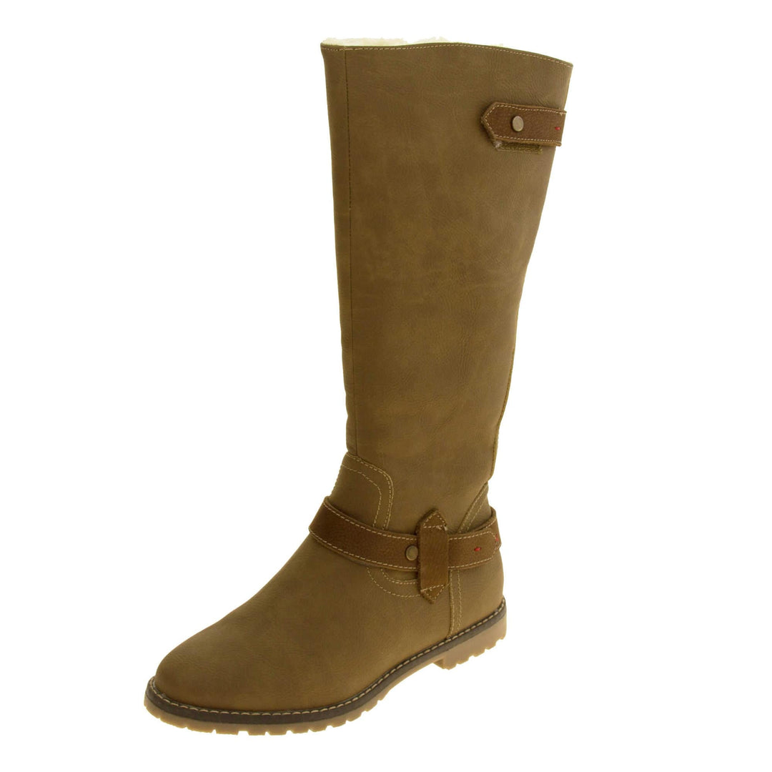 Womens brown tall boots. Almost knee high boots with a light brown faux suede upper. Brown faux leather strap around the ankle and the back half of the neck of the boot. Brown sole with chunky tread. Zip fastening down the inside of the leg. Left foot at an angle.