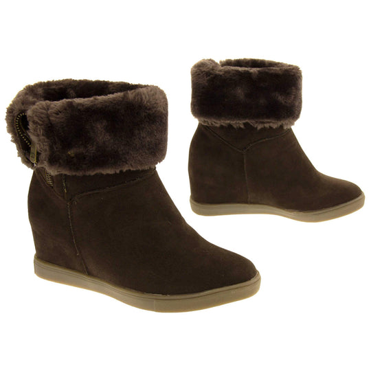 Womans calf boots. Dark brown faux suede wedge ankle boots. With zip fastening. Brown faux fur wide collar. Light brown sole with deep grip to the base. Both feet in a T shape about an inch apart.