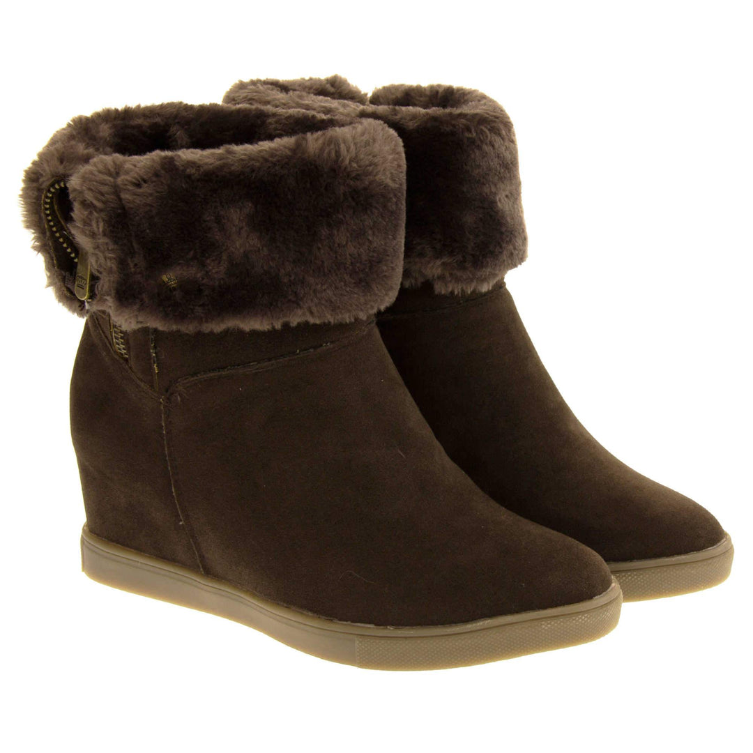 Womans calf boots. Dark brown faux suede wedge ankle boots. With zip fastening. Brown faux fur wide collar. Light brown sole with deep grip to the base. Both feet together at an angle.