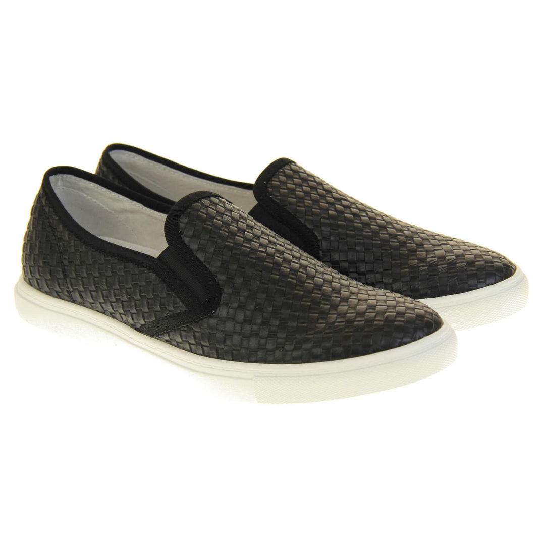Womens casual loafers. Slip on loafer style shoe with a black woven textile upper. Black elasticated side gussets and plain black textile around collar. White flat sole and cream leather lining. Both feet together at a slight angle.