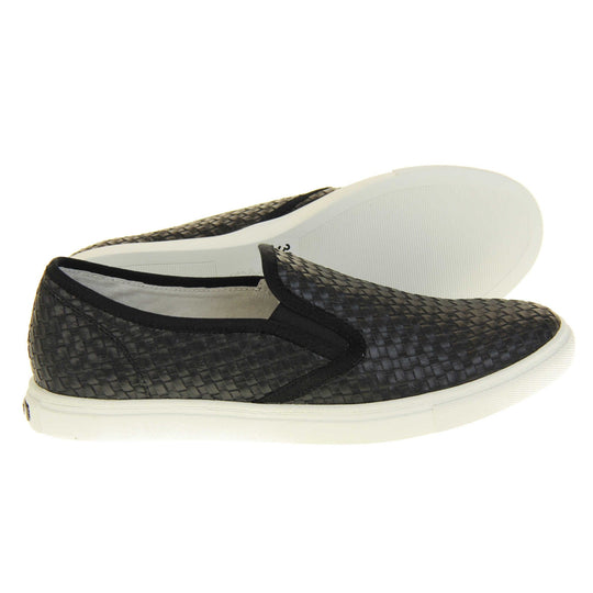 Womens casual loafers. Slip on loafer style shoe with a black woven textile upper. Black elasticated side gussets and plain black textile around collar. White flat sole and cream leather lining. Both feet from a side profile with the left foot on its side behind the the right foot to show the sole.
