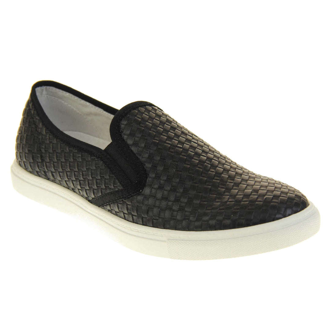 Womens casual loafers. Slip on loafer style shoe with a black woven textile upper. Black elasticated side gussets and plain black textile around collar. White flat sole and cream leather lining. Right foot at an angle.
