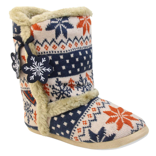 Womens Christmas Slipper Boots - Blue, beige and brown snowflake knitted upper with beige fur lining and trim. Navy blue and white snowflake shaped tassels to side. Right foot at angle.