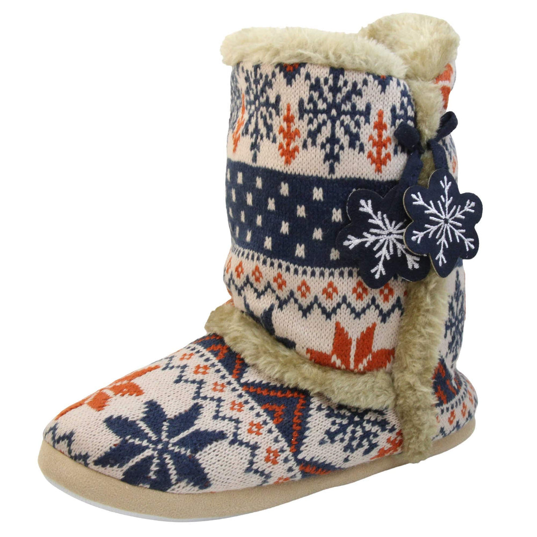 Womens Christmas Slipper Boots - Blue, beige and brown snowflake knitted upper with beige fur lining and trim. Navy blue and white snowflake shaped tassels to side. Left foot at angle.