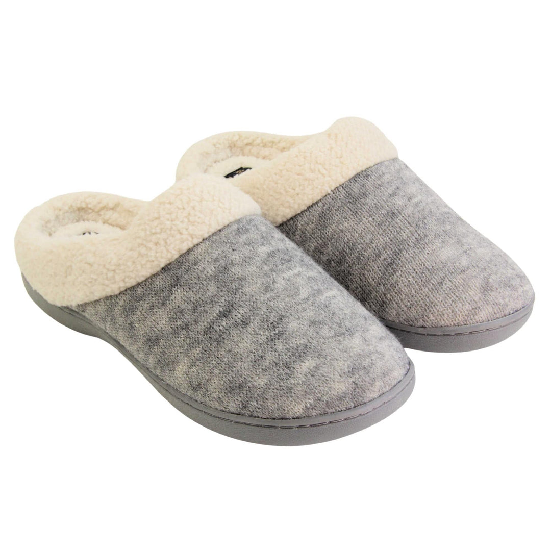 Womens cotton slippers. Womens slippers in a mule style. With grey cotton knit uppers and cream faux fur collar and lining. Grey hard synthetic soles with grip to the base. Both feet together at an angle.
