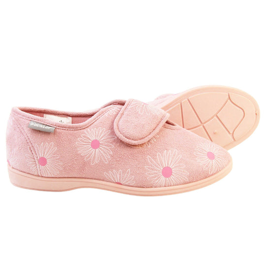 Pink flower slippers. Womens full back slipper. With a pale pink upper with white daisy design with bright pink for the middle of the flowers. Touch fasten strap over the top of the foot to adjust the fit. Pink textile lining and firm pink sole. Both feet from a side profile with the left foot on its side behind the the right foot to show the sole.