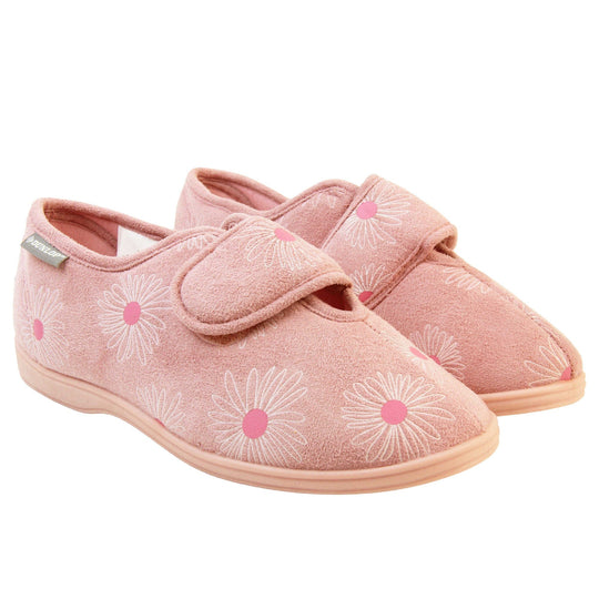 Pink flower slippers. Womens full back slipper. With a pale pink upper with white daisy design with bright pink for the middle of the flowers. Touch fasten strap over the top of the foot to adjust the fit. Pink textile lining and firm pink sole. Both feet together at angle.