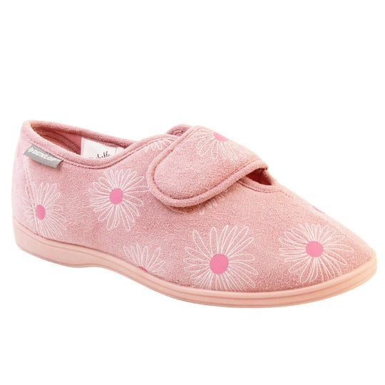 Pink flower slippers. Womens full back slipper. With a pale pink upper with white daisy design with bright pink for the middle of the flowers. Touch fasten strap over the top of the foot to adjust the fit. Pink textile lining and firm pink sole. Right foot at an angle.