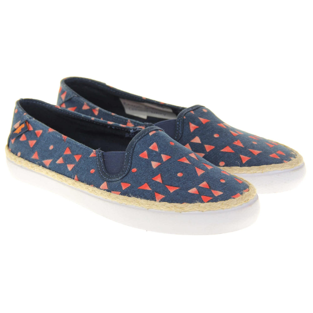 Womens espadrille flats. Plimsoll style shoes with a navy blue canvas upper with a red triangle design on it. Small Rocket Dog label to the heel. White outsole with espadrille rope around the top. Both feet together at a slight angle.