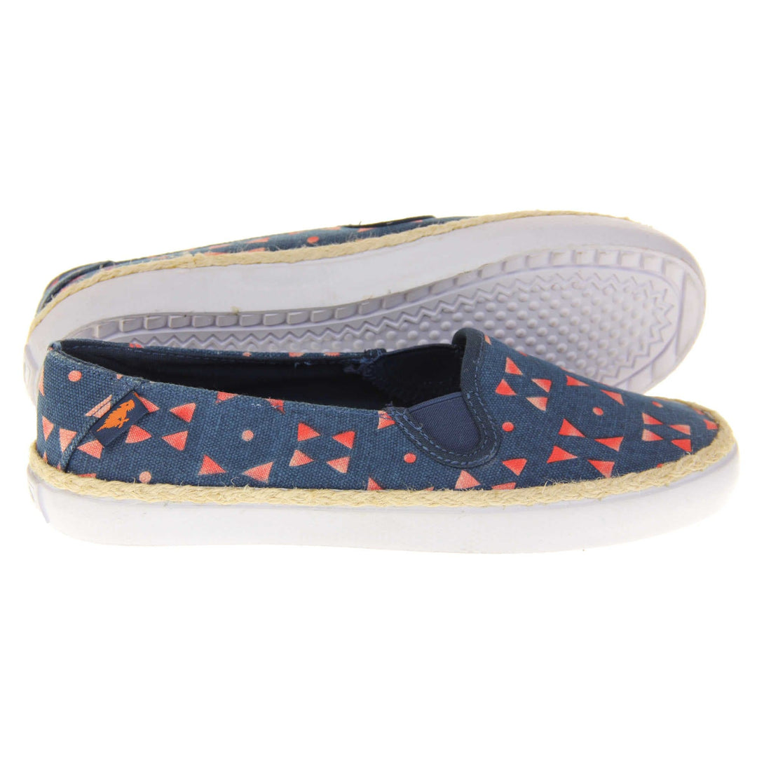 Womens espadrille flats. Plimsoll style shoes with a navy blue canvas upper with a red triangle design on it. Small Rocket Dog label to the heel. White outsole with espadrille rope around the top.  Both feet from a side profile with the left foot on its side behind the the right foot to show the sole.