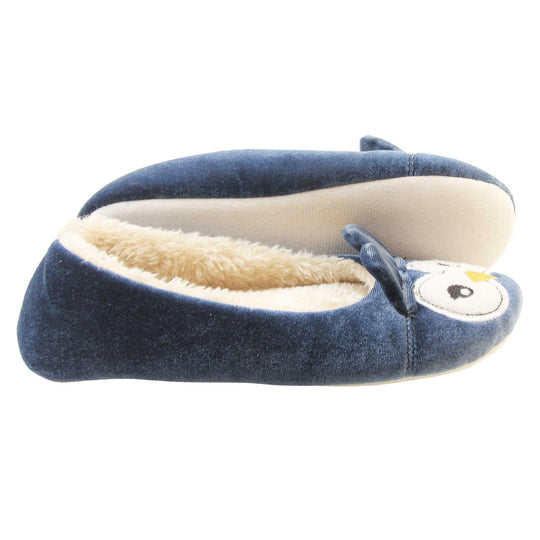 Owl slippers womens. Ladies slippers in a ballerina style. With blue velvety upper, cute embroidered owl face and blue ears. White faux fur lining. Beige textile sole with bumps to the bottom for grip. Both feet from a side profile with the left foot on its side to show the sole.