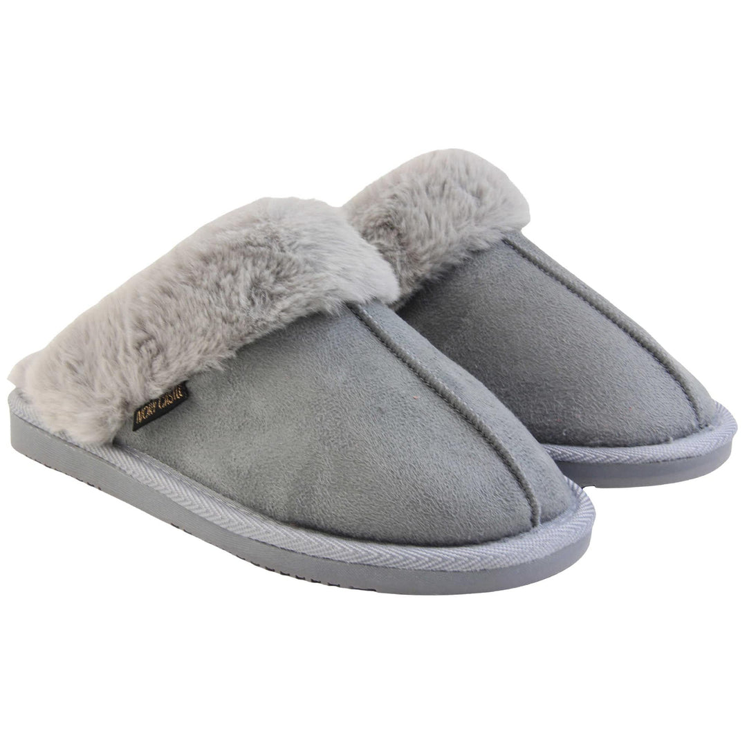 Womens faux fur mule slippers. Slip on style slippers with light grey faux suede uppers. Light grey faux fur lining and collar. Firm grey outsole with grip on the bottom. Both feet together at an angle.