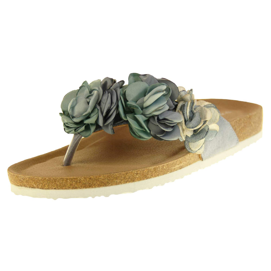 Womens Blue Floral Sandals - Stunning festival style flowers across the top strap in different shades of blue and cream with toepost to front. Soft tan faux leather footbed sandals with white soles. Perfect for weddings, beaches, holidays or casual wear. Angled left side view.