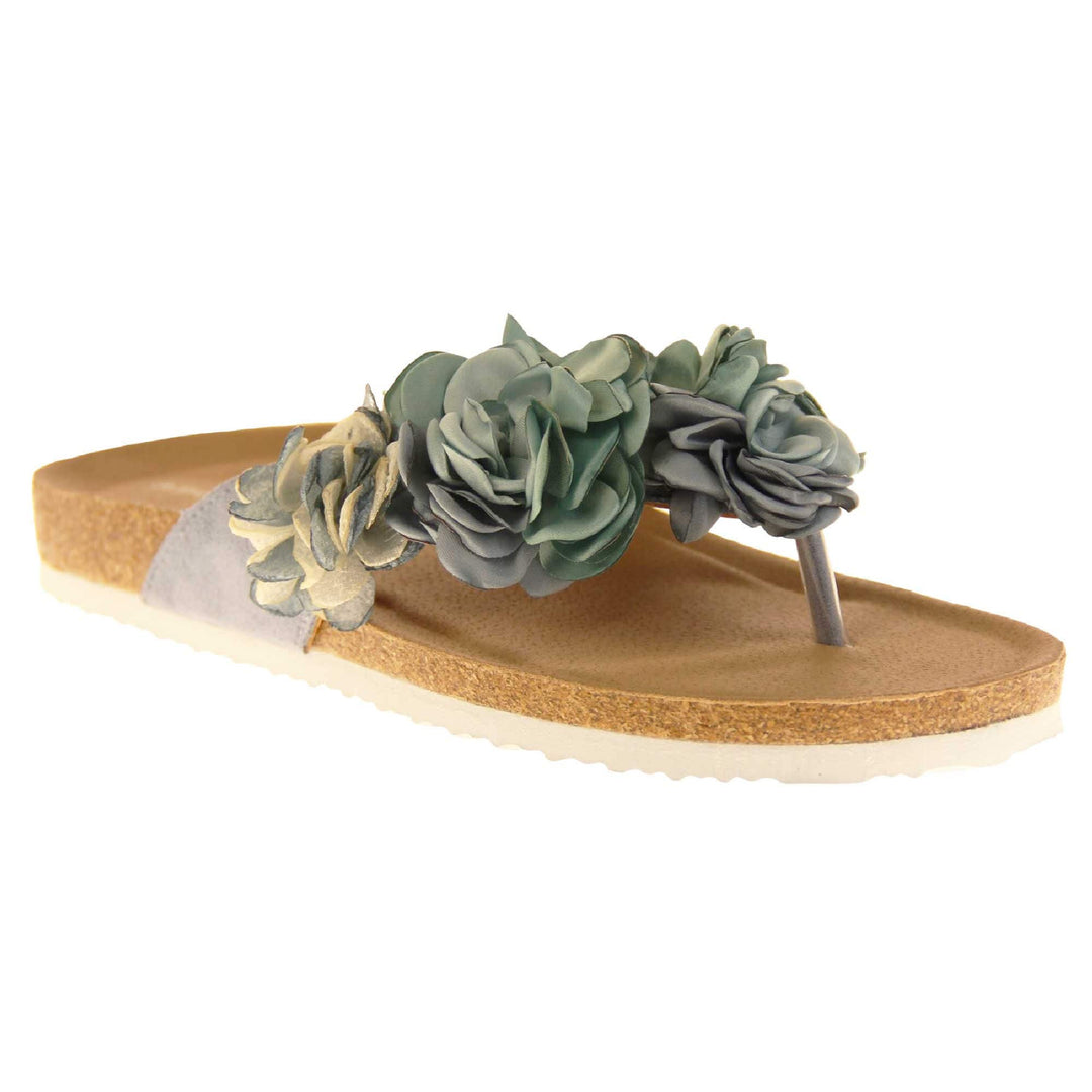 Womens Blue Floral Sandals - Stunning festival style flowers across the top strap in different shades of blue and cream with toepost to front. Soft tan faux leather footbed sandals with white soles. Perfect for weddings, beaches, holidays or casual wear. Angled right side view.