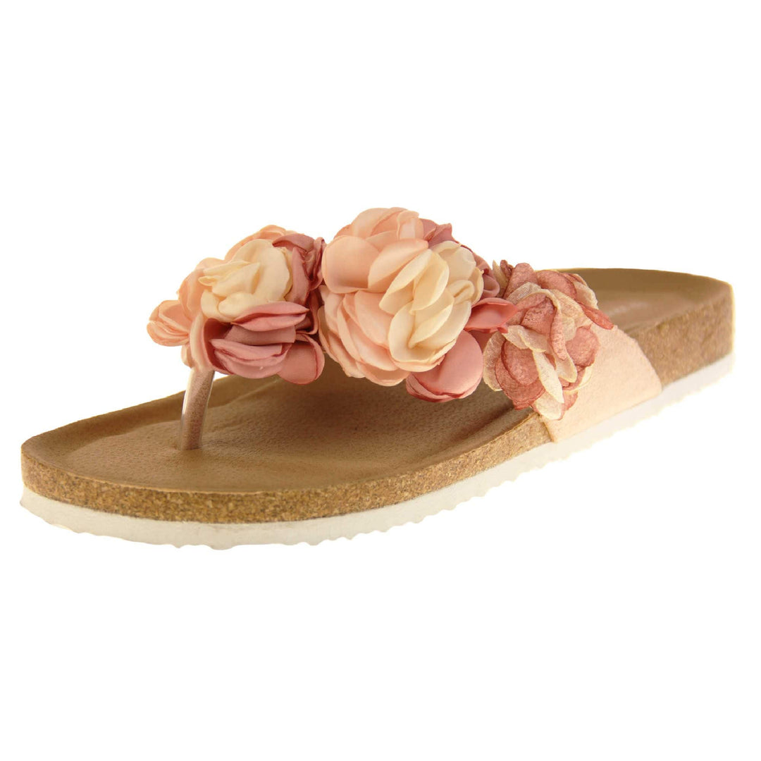 Womens Pink Floral Sandals - Stunning festival style flowers across the top strap in different shades of pink and cream with toepost to front. Soft tan faux leather footbed sandals with white soles. Perfect for weddings, beaches, holidays or casual wear. Angled left side view.