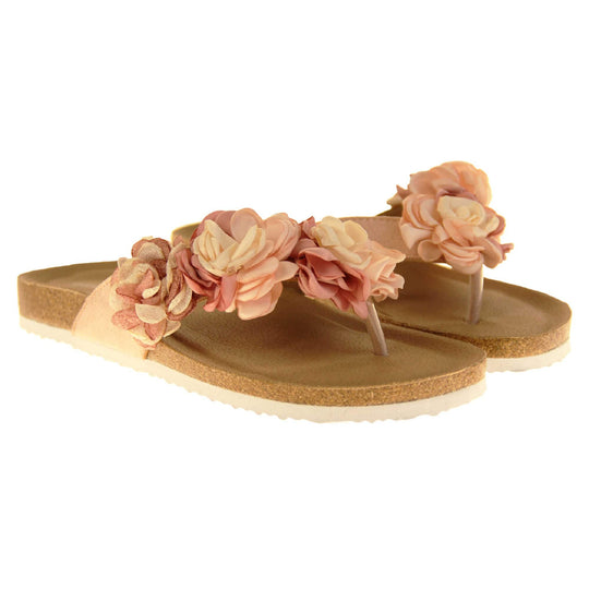 Womens Pink Floral Sandals - Stunning festival style flowers across the top strap in different shades of pink and cream with toepost to front. Soft tan faux leather footbed sandals with white soles. Perfect for weddings, beaches, holidays or casual wear. Both feet angled view.