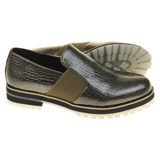 Womens green loafer. Loafer style shoes with a khaki faux snakeskin upper. With twin khaki elasticated side panels. Chunky black and cream sole with slip resistant grip to the bottom. Both feet from a side profile with the left foot on its side behind the the right foot to show the sole.