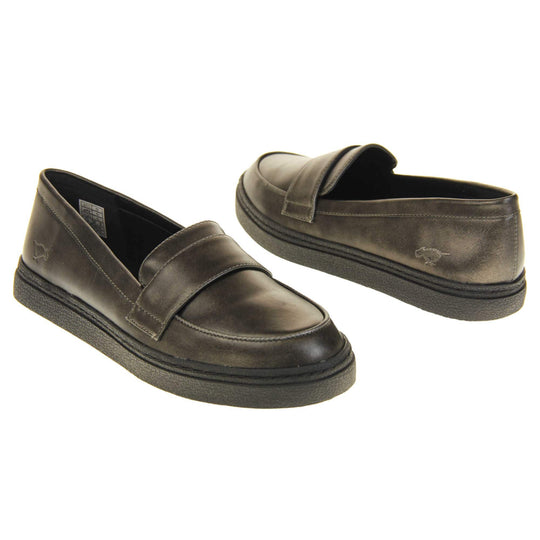 Women's grey loafer. Loafer style shoes with a pewter grey faux leather upper. With a bar detail over the foot. Rocket Dog logo to the outside heel. Chunky black sole with slip resistant grip to the bottom. Both feet at an angle facing top to tail.