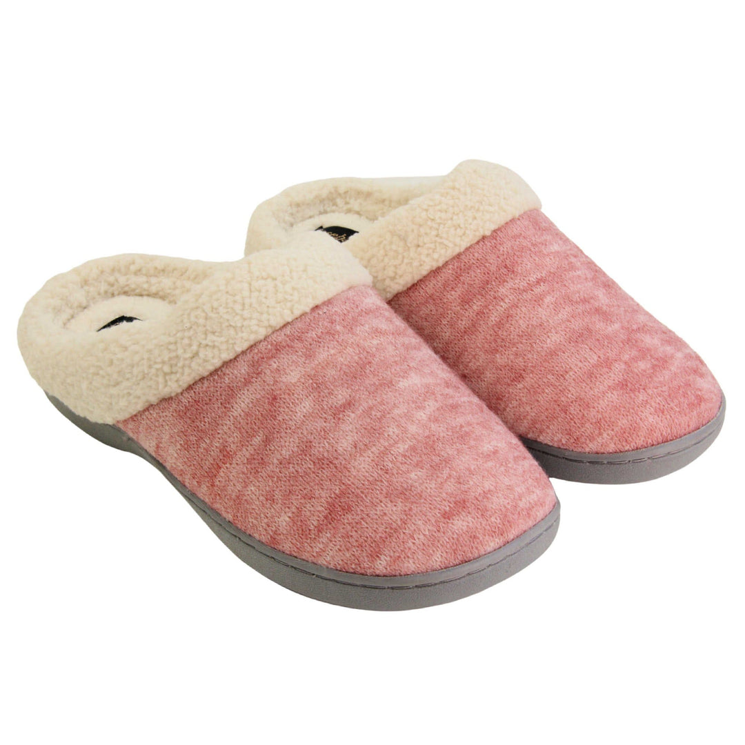 Womens hard sole slippers. Womens slippers in a mule style. With pink cotton knit uppers and cream faux fur collar and lining. Grey hard synthetic soles with grip to the base. Both feet together at an angle.
