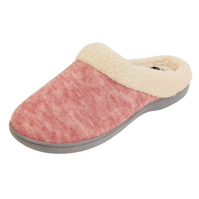 Womens hard sole slippers. Womens slippers in a mule style. With pink cotton knit uppers and cream faux fur collar and lining. Grey hard synthetic soles with grip to the base. Left foot at an angle.