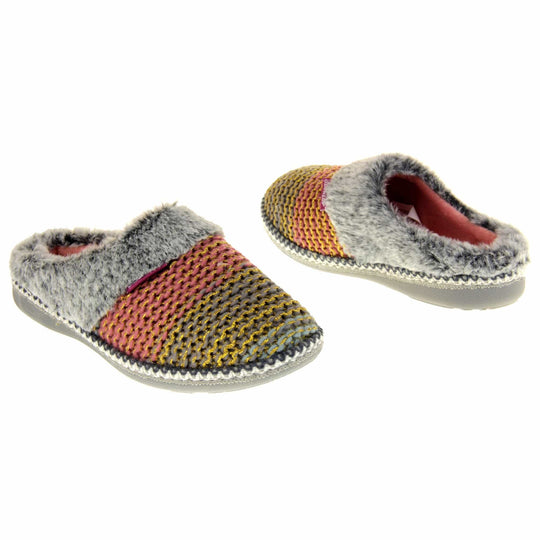 Womens knit slippers. Mule style slippers with pink and blue knit uppers with metallic gold thread running through. Grey faux fur collar. Pink textile lining and firm grey outsole with grip on the bottom. Both feet at an angle, facing top to tail.