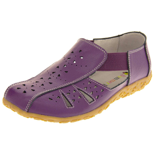 Womens leather sandals. Purple leather closed toe sandals with white stitched detailing. With small cut out details on the upper. Purple elasticated strips from tongue to ankle to allow more room for a better fit. Cream coloured leather insole and lining. Brown sole with heel having a slight platform with raised flower design for grip. Left foot at an angle.