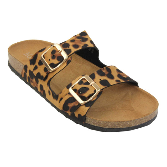 Leopard print sandals. Womens dual strap slip on sandals. With a leopard print synthetic suede upper with a gold buckle on each strap. Brown faux suede insole with a moulded footbed. Cork effect outsole with black base with grip to the bottom. Right foot at an angle.