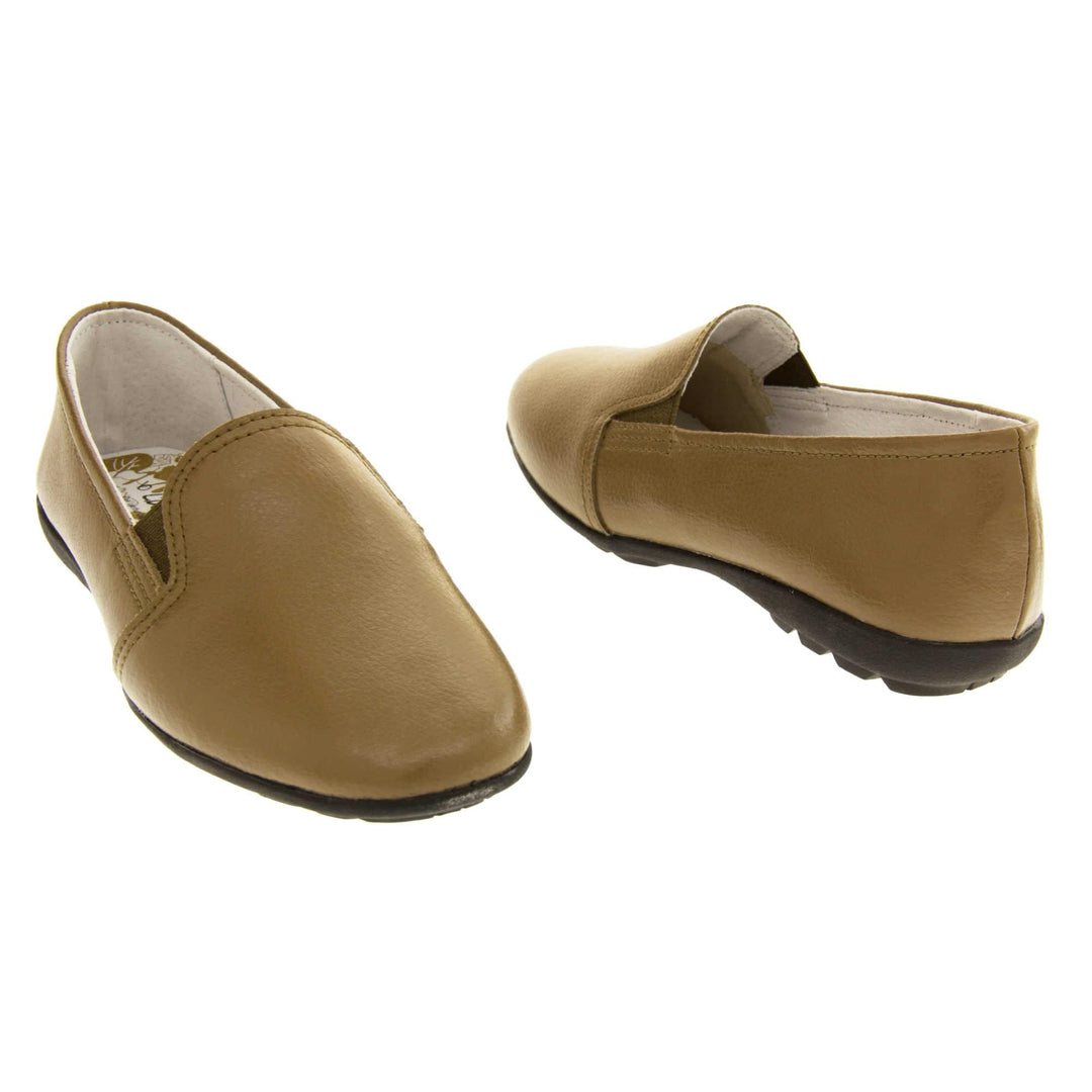 Women's loafers brown. Slip on loafer style shoes with a taupe leather upper. Brown elasticated gusset. Black sole with grip to the bottom. Both feet at an angle facing top to tail.