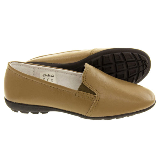 Women's loafers brown. Slip on loafer style shoes with a taupe leather upper. Brown elasticated gusset. Black sole with grip to the bottom. Both feet from a side profile with the left foot on its side behind the the right foot to show the sole.