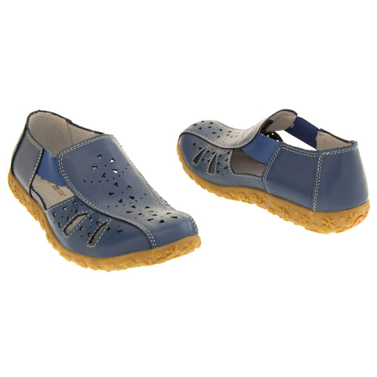 Womens navy sandals. Navy blue leather closed toe sandals with white stitched detailing. With small cut out details on the upper. Blue elasticated strips from tongue to ankle to allow more room for a better fit. Cream coloured leather insole and lining. Brown sole with heel having a slight platform with raised flower design for grip. Both feet at a slight angle facing top to tail.