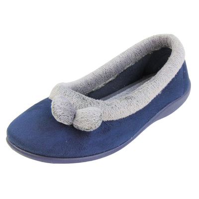 Womens navy slippers. Womens ballerina style slippers with navy blue velour uppers. Grey, plush textile collar and two pom poms to the front of the shoe. Matching textile lining. Firm navy sole. Left foot at an angle.