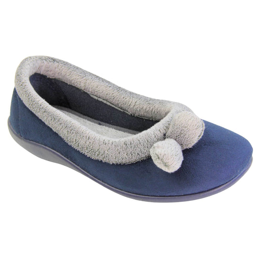 Womens navy slippers. Womens ballerina style slippers with navy blue velour uppers. Grey, plush textile collar and two pom poms to the front of the shoe. Matching textile lining. Firm navy sole. Right foot at an angle.