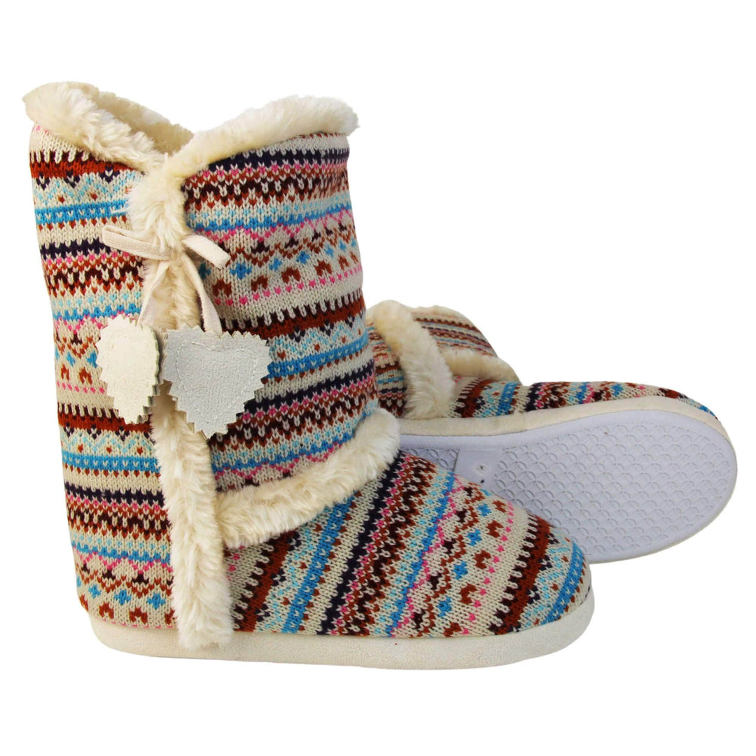 Womens Nordic Slipper Boots - Cream multi Christmas knit upper in nordic & scandinavian style with felt love heart tassles to the side, light beige plush faux fur trim and lining. Both feet with outsole showing.