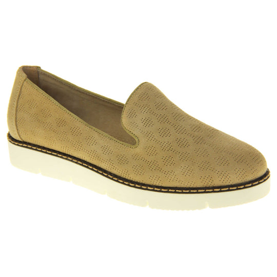 Womens platform loafers. Loafer style shoes with a beige faux-suede upper with pin size dot cut-outs. Plain beige strip over the heel for added support. White flat chunky platform outsole with black rim along the top and beige stitching detail. Cream leather lining. Right foot at an angle.