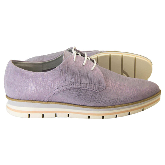 Womens purple dress shoes. Womens oxford style shoes with a lavender metallic faux leather upper. Stitching detail to the sides. Cream laces and beige lining and cream, orange and lilac layered platform sole. Both feet from a side profile with the left foot on its side behind the the right foot to show the sole.