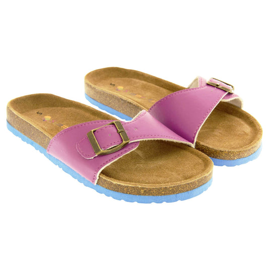 Womens purple sandals. Purple faux leather strap with gold buckle. Soft tan faux suede footbed with cork effect outsole and blue sole. Both feet together at a slight angle.