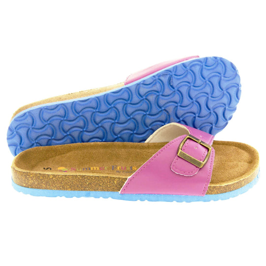 Womens purple sandals. Purple faux leather strap with gold buckle. Soft tan faux suede footbed with cork effect outsole and blue sole. Both feet from a side profile with the left foot on its side behind the the right foot to show the sole