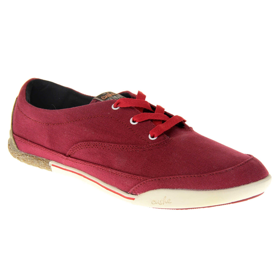 Women's Red Pumps. Sneaker style shoes with a red canvas upper and red laces. Cushe Hoffman label on the tongue. White and red outsole with the heel being espadrille style. Right foot at an angle.