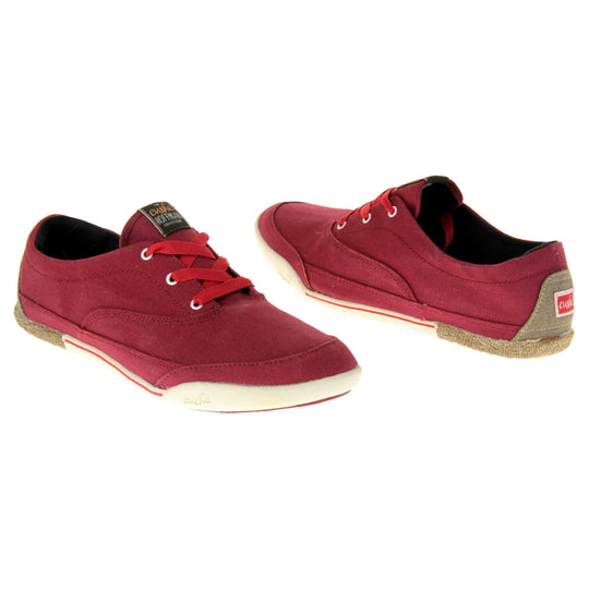 Women's Red Pumps. Sneaker style shoes with a red canvas upper and red laces. Cushe Hoffman label on the tongue. White and red outsole with the heel being espadrille style. Both feet at an angle facing top to tail.